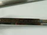 a close up of a sword on a white surface