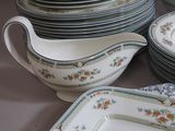 a lot of plates and bowls that are on a table