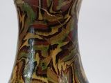 a vase that has a brown and green design on it