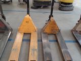 four forklifts sitting on the floor in a warehouse