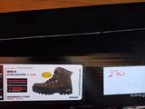 someone is holding a box with a pair of hiking boots on it