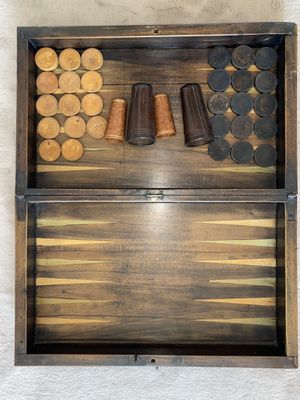 an image of a wooden backgam board with several pieces of wood in it