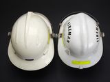 two hard hats that are sitting next to each other