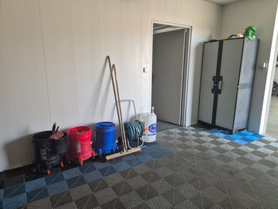 a room that has a bunch of trash cans and a rack in it