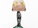an art deco lamp with a green base and a marble shade
