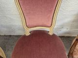two chairs with pink velvet upholstered and gold trim on them