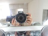 a person taking a picture of themselves in the mirror