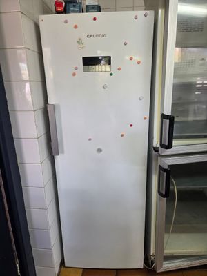 un réfrigérateur blanc dans le coin d'une pièce