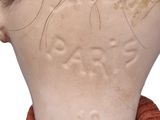 a close up of a doll ' s head and neck