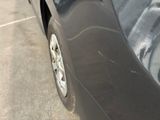a car that has been painted black in the parking lot