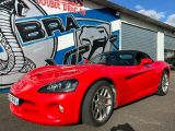 a red sports car parked in front of a building