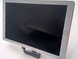 a tablet that is sitting on a stand on a table
