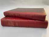 two red books sitting on top of each other on a table
