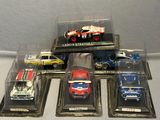 five different models of cars in a display case