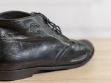 a close up of a pair of black shoes on a table