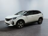 Un SUV blanc est garé dans une pièce au sol noir.