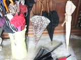 many umbrellas that are sitting in a bucket on the floor