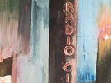 a painting of a street sign on the side of a building