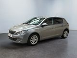 a silver car is parked in a room with a white wall