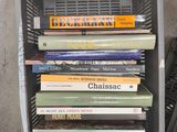 a stack of books sitting on top of a metal crate