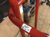 a red ladder with a sticker on it in a room