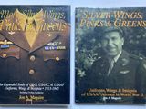 two book covers of two different military uniforms on a table