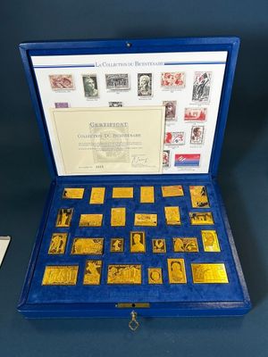 an open blue box containing a collection of stamps and stamps