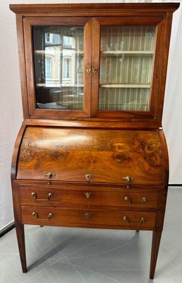 an old wooden secretary desk with glass doors and drawers