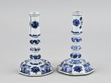 pair of blue and white candlesticks with floral designs