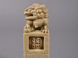 an image of a stone statue of a lion on a pedestal