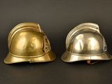 two helmets sitting next to each other on a black surface