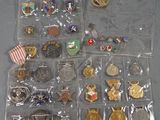 many different types of badges and pins in the bag