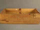 an old wooden box with a label on it sitting on top of a table