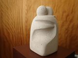 a white sculpture sitting on top of a wooden table