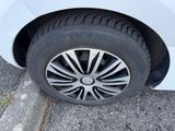a close up of a tire on a white car