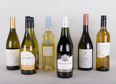 several bottles of wine are lined up in a row on a table