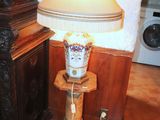 a lamp that is sitting on a table next to a cabinet