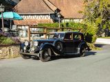 a vintage car that is parked on the side of the road