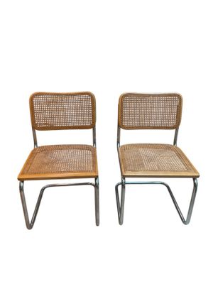pair of vintage chairs with wicker backrests and chrome legs