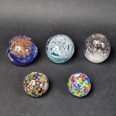 six glass marbles sitting on top of a table next to each other
