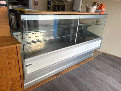 a glass display case in the middle of a kitchen