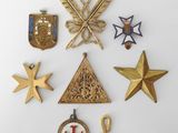 an image of a collection of medals and other items on a white surface