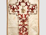 a close up of a white and red cross on a white background
