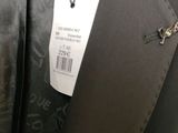 a close up of a suit with a tag on it