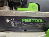 a close up of a green and black circular saw