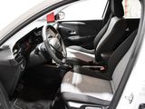 the interior of a white car with black seats and a steering wheel