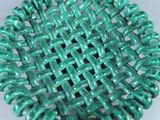 turquoise green glass beaded bracelet with woven design on a white background