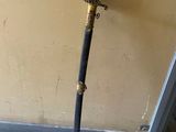 a small sword that is leaning against a wall