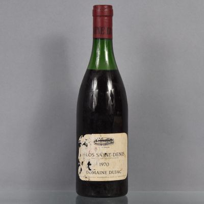 a bottle of wine sitting on top of a glass table