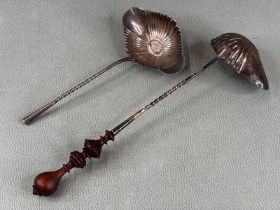 two spoons that are sitting next to each other